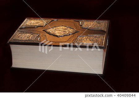 Ancient book in luxurious binding on black  40409844