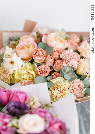 two bouquet of beautiful flowers on gray table. Floristry concept. Spring colors. the work of the 40411331