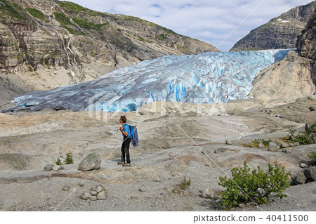 A mountain guide in front of Nigardsbreen, a glacier arm of the large Jostedalsbreen glacier, Norway A mountain guide in front of Nigardsbreen, a glacier arm of the large Jostedalsbreen glacier, Norway 40411500