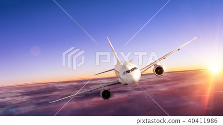 Airplane flying above clouds in dramatic sunset 40411986