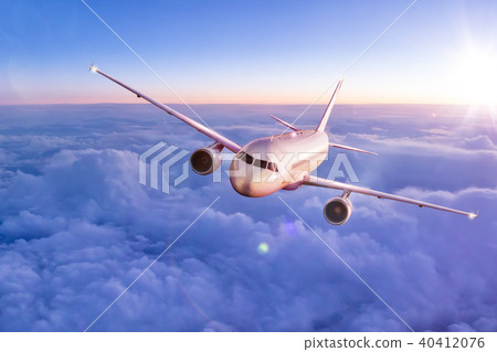 Commercial airplane flying above clouds 40412076