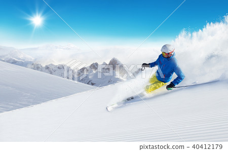 Skier skiing downhill in high mountains 40412179