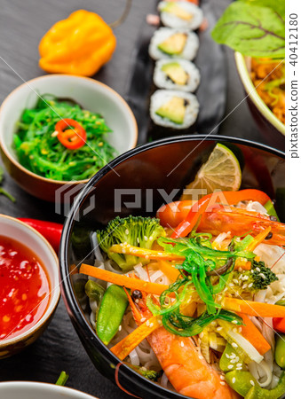 Asian food served on black stone Asian food served on black stone 40412180