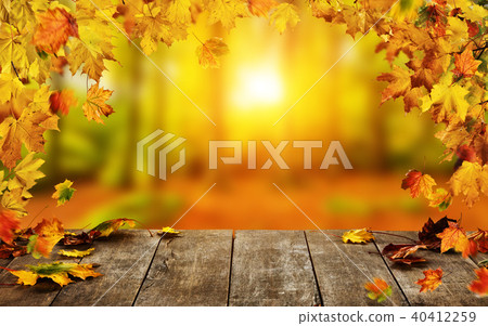 Autumn background with falling leaves and empty wooden table Autumn background with falling leaves and empty wooden table 40412259