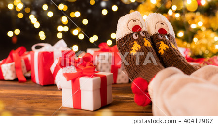 Woman feet in woollen socks, blur Christmas background Woman feet in woollen socks, blur Christmas background 40412987