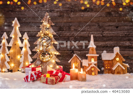 Holidays background with illuminated Christmas tree, gifts and wooden village. 40413080