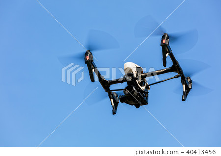 Drone flying against blue sky background Drone flying against blue sky background 40413456