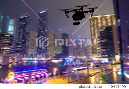 Drone silhouette flying above Dubaicity panorama 40413499