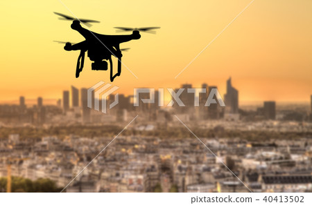Drone silhouette flying above Paris city panorama Drone silhouette flying above Paris city panorama 40413502