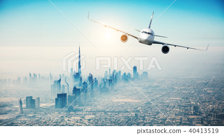 Commercial airplane flying over modern city Commercial airplane flying over modern city 40413519