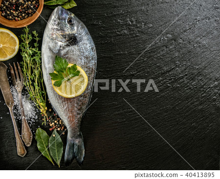 Fresh sea fish placed on dark stone background 40413895