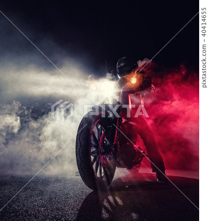 High power motorcycle chopper with man rider at night 40414655