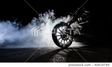 High power motorcycle chopper with man rider at night High power motorcycle chopper with man rider at night 40414749