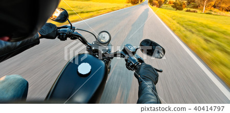 Motorcycle driver riding on motorway 40414797