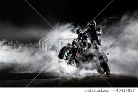 High power motorcycle chopper with man rider at night 40414857