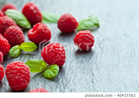Heap of raspberry on stone 40415562