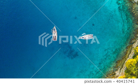 Aerial view of two sailing boats anchoring next to reef 40415741