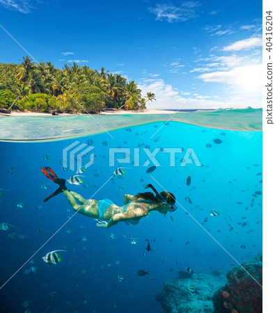 Young woman snorkling on tropical beach 40416204