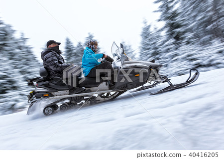 Snowmobile on winter forest road 40416205