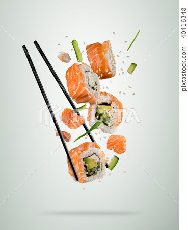 Flying sushi pieces with chopsticks, separated on soft background Flying sushi pieces with chopsticks, separated on soft background 40416348