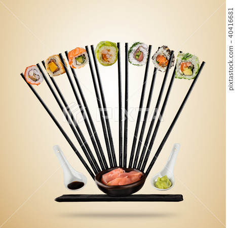 Sushi pieces with chopsticks served on plate, separated on colored background 40416681