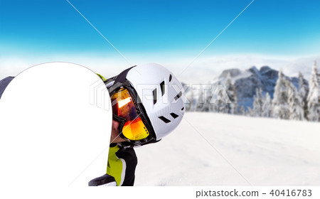 Snowboarder holding his snowboard off piste 40416783