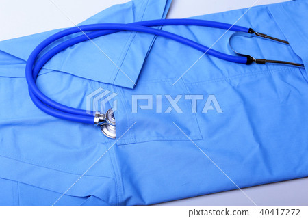Medical stethoscope lying on patient medical history list, RX prescription and blue doctor uniform 40417272