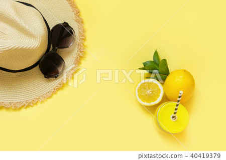 Straw beach foman's hat and black sun glasses. Straw beach foman's hat and black sun glasses. 40419379