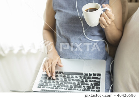 Working woman sitting on the sofa. 40420596