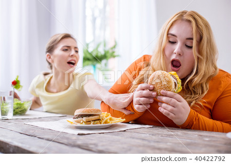 Satisfied fat woman eating a sandwich Satisfied fat woman eating a sandwich 40422792
