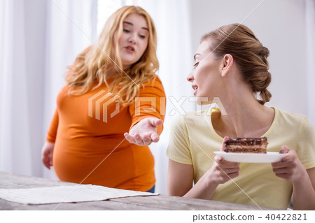 Excited plump woman wanting a dessert 40422821