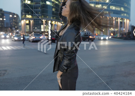 Beautiful woman on a background of a night city and passing cars. Beautiful woman on a background of a night city and passing cars. 40424184