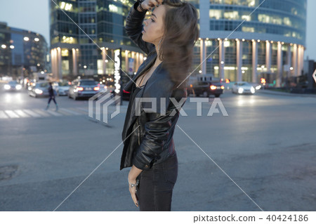 Beautiful woman on a background of a night city and passing cars. Beautiful woman on a background of a night city and passing cars. 40424186