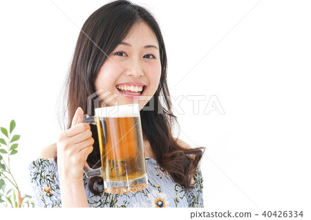 Young woman drinking beer Young woman drinking beer 40426334