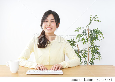 Young woman using a personal computer Young woman using a personal computer 40426861