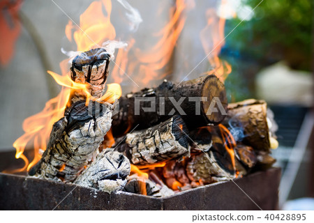 Burning logs in brazier at daylight Burning logs in brazier at daylight 40428895