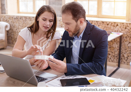 Reflective two designers debating over interior plan Reflective two designers debating over interior plan 40432242