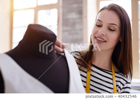 Positive female dressmaker fitting dress Positive female dressmaker fitting dress 40432546