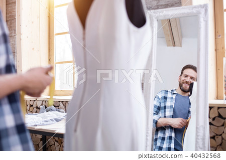 Happy male couturier admiring dress Happy male couturier admiring dress 40432568