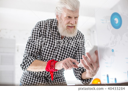 White-haired senior man checking data from screen 40433284