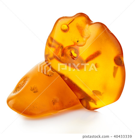 pieces of amber close-up isolated on a white. pieces of amber close-up isolated on a white. 40433339
