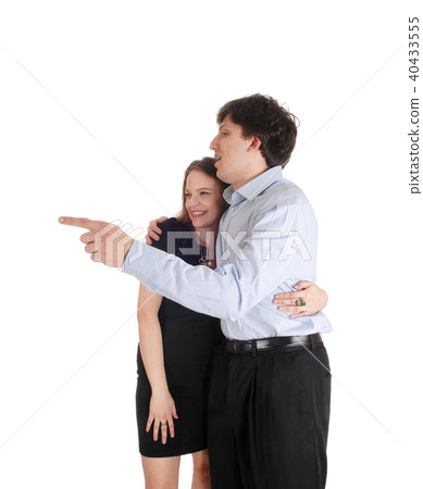 Young couple standing, man is pointing Young couple standing, man is pointing 40433555