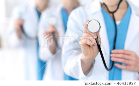 Groupe of medicine doctors hold stethoscope head closeup. Physicians ready to examine and help 40433957