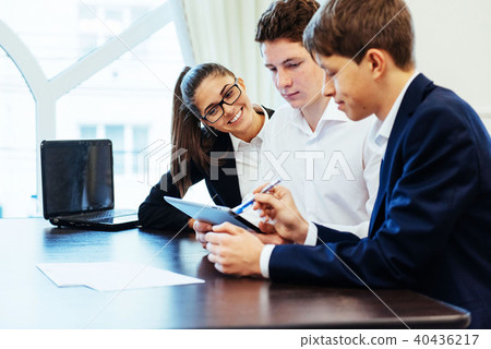 Group of students studying using a laptop Group of students studying using a laptop 40436217