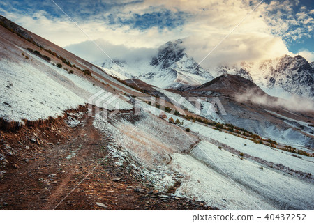 Mountain landscape of snow-capped mountains in the mist Mountain landscape of snow-capped mountains in the mist 40437252