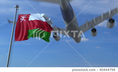 Commercial airplane flying above waving flag of Oman. 3D rendering 40444798