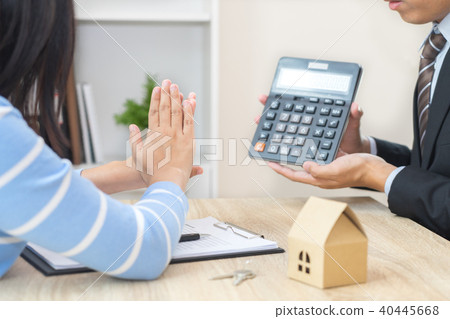 Businessman showing the home price on calculator Businessman showing the home price on calculator 40445668