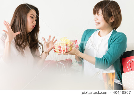A woman giving a gift for a friend A woman giving a gift for a friend 40448807