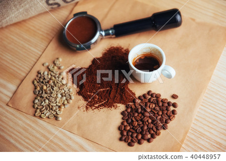 Top view a cup of coffee and three different varieties 40448957