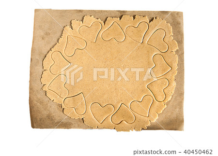 Roll out the dough to cut out heart shapes isolate 40450462